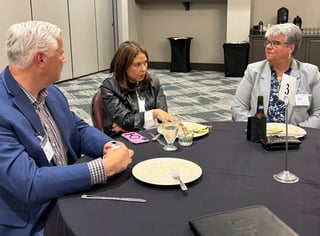 Photo of Clean Fuels Michigan members speaking with Laura Mester at dinner